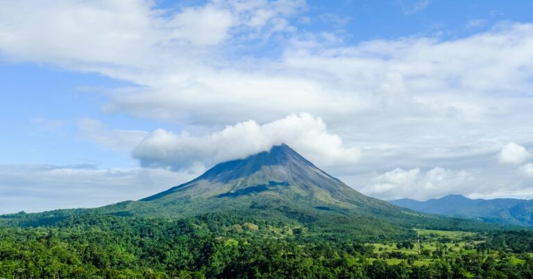 green mountain under blue sky and white clouds during daytime